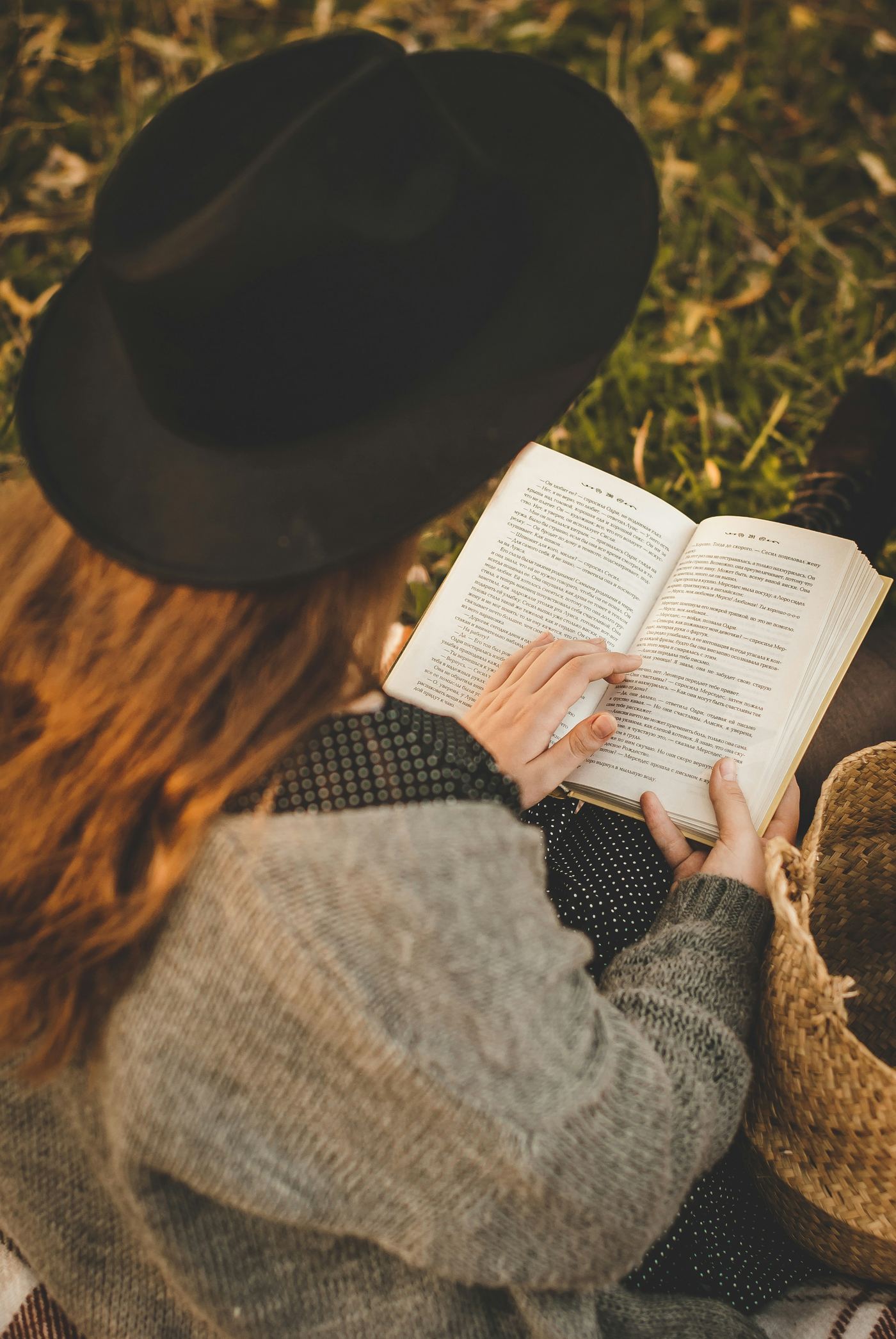 A student reading outdoors in the sunshine