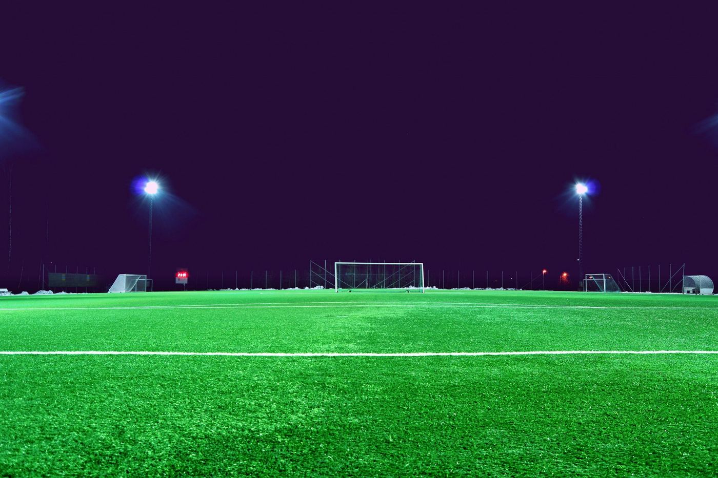 A floodlit football pitch at dusk